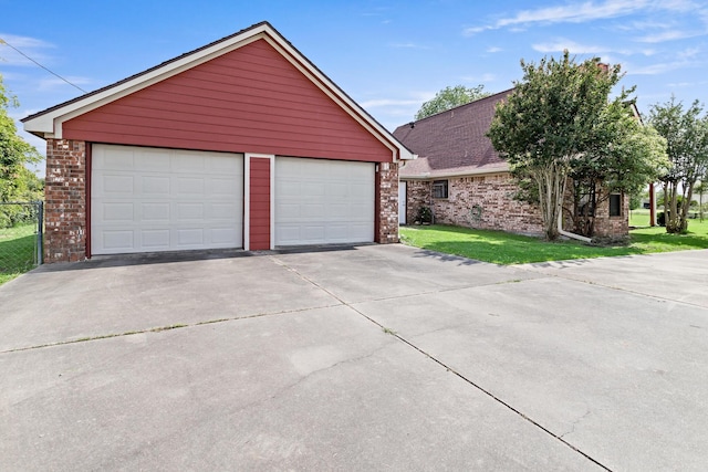 11161 Blue Bonnet Ln, Beaumont, TX 77705 - view of front of house featuring brick siding, a detached garage, an outbuilding, and a front yard