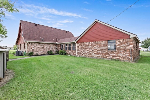 11161 Blue Bonnet Ln, Beaumont, TX 77705 - rear view of property featuring brick siding, a yard, roof with shingles, and cooling unit