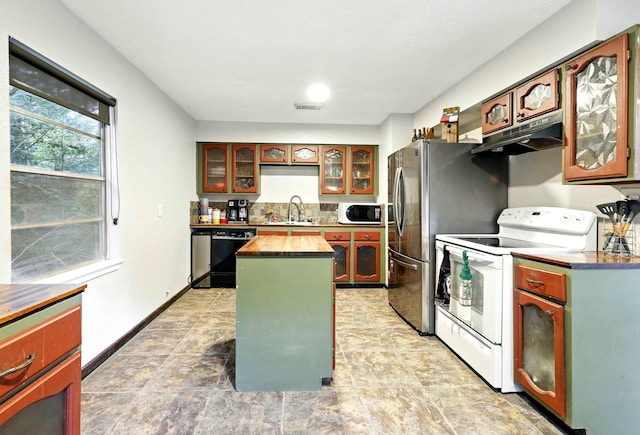 71 White Oak St, Point Blank, TX 77364 - kitchen featuring white appliances, under cabinet range hood, a sink, a center island, and butcher block countertops