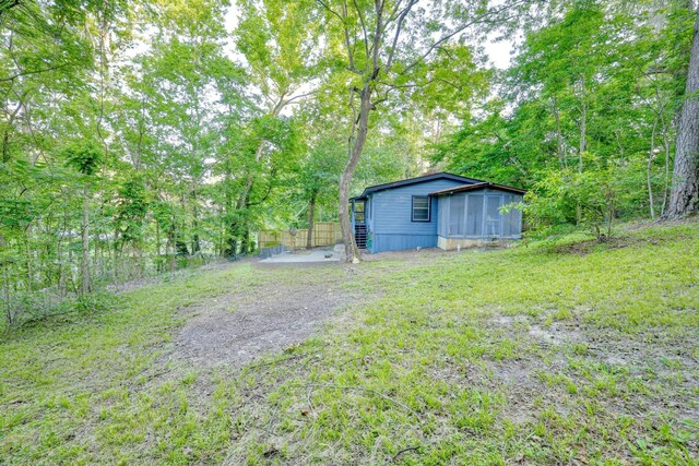 71 White Oak St, Point Blank, TX 77364 - view of yard featuring a sunroom and a view of trees
