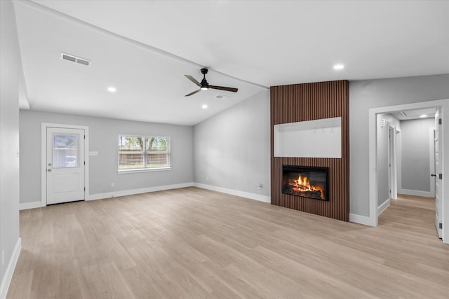 607 Mary Ann Dr, Friendswood, TX 77546 - unfurnished living room featuring ceiling fan, light wood-style floors, vaulted ceiling, a glass covered fireplace, and recessed lighting