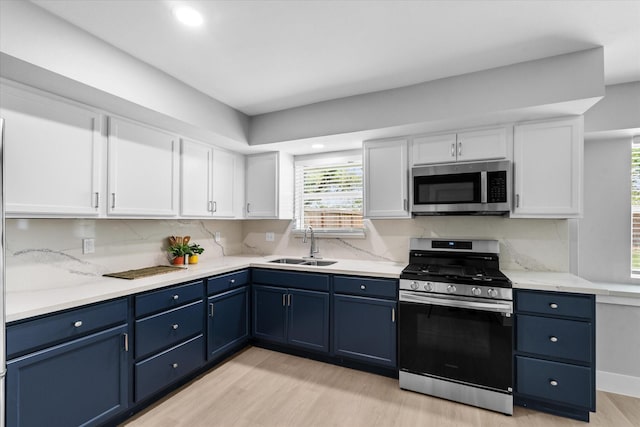 607 Mary Ann Dr, Friendswood, TX 77546 - kitchen featuring appliances with stainless steel finishes, blue cabinetry, healthy amount of natural light, and recessed lighting