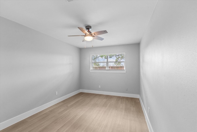 607 Mary Ann Dr, Friendswood, TX 77546 - spare room featuring a ceiling fan, light wood-style floors, and baseboards