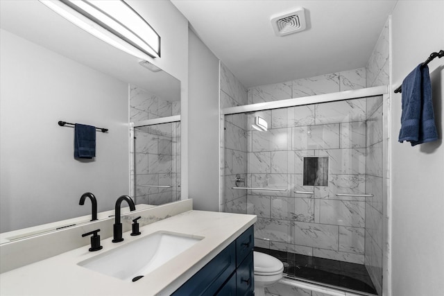 607 Mary Ann Dr, Friendswood, TX 77546 - bathroom featuring marble look tile flooring, toilet, vanity, and a marble finish shower