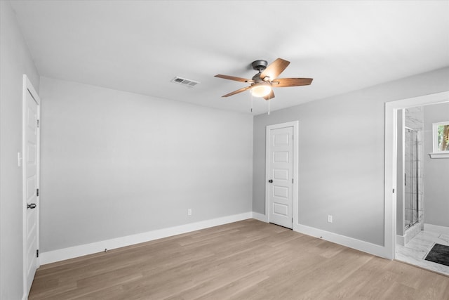 607 Mary Ann Dr, Friendswood, TX 77546 - unfurnished bedroom featuring baseboards, light wood finished floors, connected bathroom, and ceiling fan
