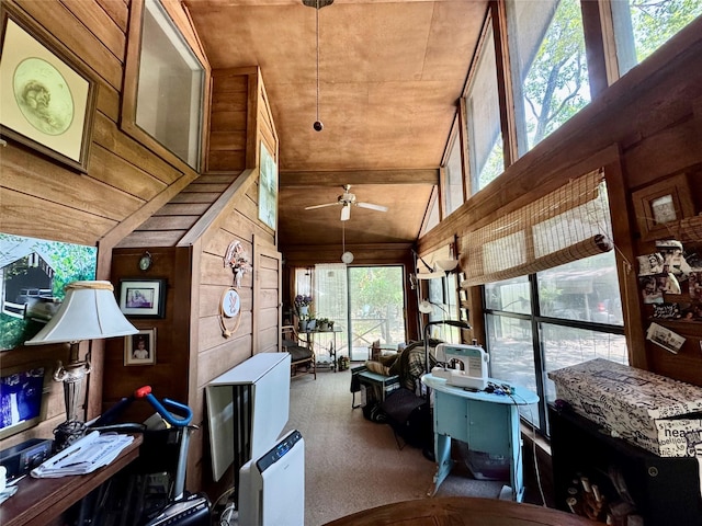 1347 Cardinal Ln, Trinity, TX 75862 - living room with wood walls, ceiling fan, carpet, and vaulted ceiling