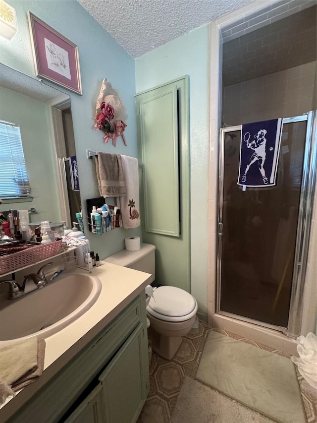 1347 Cardinal Ln, Trinity, TX 75862 - bathroom with vanity, a shower stall, toilet, and a textured ceiling