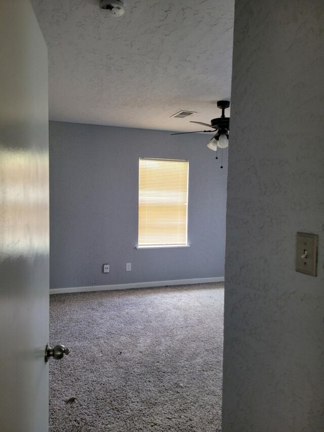 5754 Belarbor St, Houston, TX 77033 - empty room featuring ceiling fan, carpet flooring, baseboards, and a textured ceiling