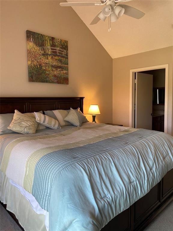 8435 Sands Point Dr, Houston, TX 77036 - carpeted bedroom featuring lofted ceiling and ceiling fan