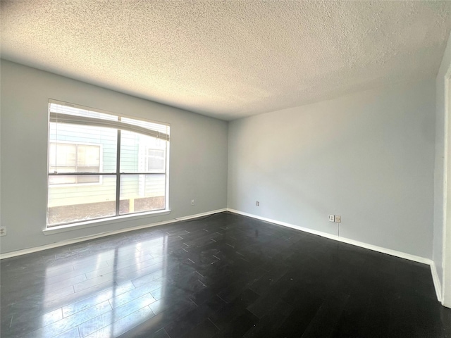 3754 Tanglewilde St Unit 9, Houston, TX 77063 - spare room featuring dark wood-style flooring, baseboards, and a textured ceiling