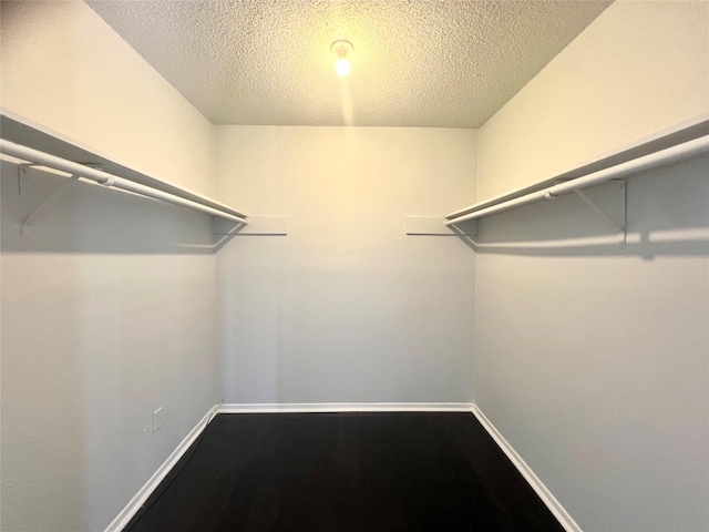 3754 Tanglewilde St Unit 9, Houston, TX 77063 - walk in closet with dark wood-style floors