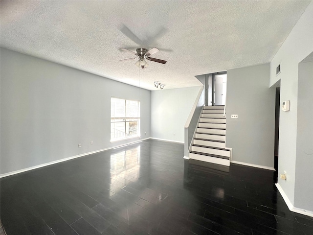 3754 Tanglewilde St Unit 9, Houston, TX 77063 - unfurnished living room featuring a ceiling fan, a textured ceiling, baseboards, dark wood-type flooring, and stairs