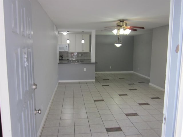 9797 Leawood Blvd Unit 1411, Houston, TX 77099 - unfurnished living room with ceiling fan, light tile patterned flooring, and baseboards