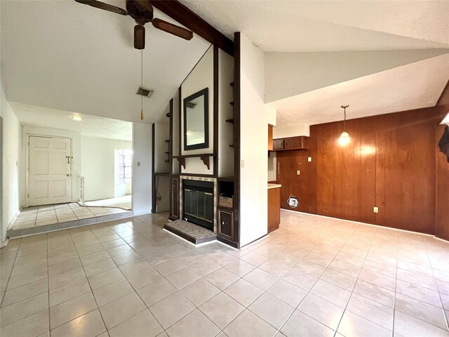 4306 Rosebud Dr, Houston, TX 77053 - unfurnished living room with light tile patterned floors, a ceiling fan, high vaulted ceiling, wooden walls, and beamed ceiling
