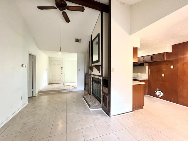 4306 Rosebud Dr, Houston, TX 77053 - unfurnished living room with a glass covered fireplace, ceiling fan, high vaulted ceiling, light tile patterned floors, and beam ceiling