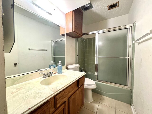 4306 Rosebud Dr, Houston, TX 77053 - bathroom featuring toilet, tile patterned floors, vanity, enclosed tub / shower combo, and a textured ceiling