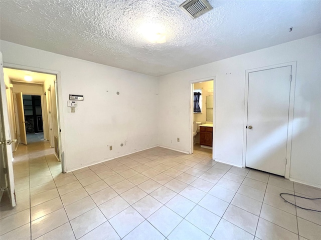 4306 Rosebud Dr, Houston, TX 77053 - spare room featuring light tile patterned floors and a textured ceiling