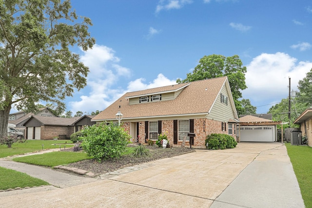 2218 Cherry Ln, Pasadena, TX 77502 - view of front of home with a front lawn, brick siding, a shingled roof, and driveway