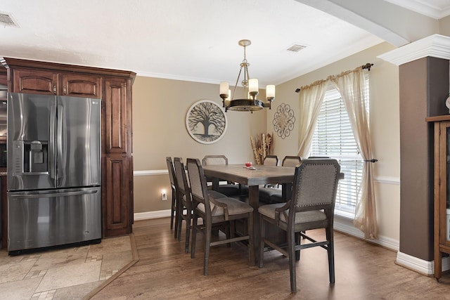 2218 Cherry Ln, Pasadena, TX 77502 - dining area featuring baseboards, a chandelier, light wood finished floors, and crown molding