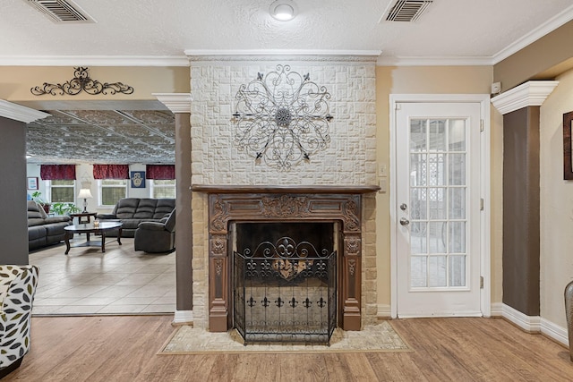 2218 Cherry Ln, Pasadena, TX 77502 - living room featuring wood finished floors, a large fireplace, baseboards, and crown molding