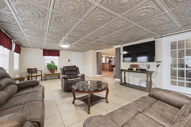 2218 Cherry Ln, Pasadena, TX 77502 - tiled living area with baseboards, decorative columns, and an ornate ceiling