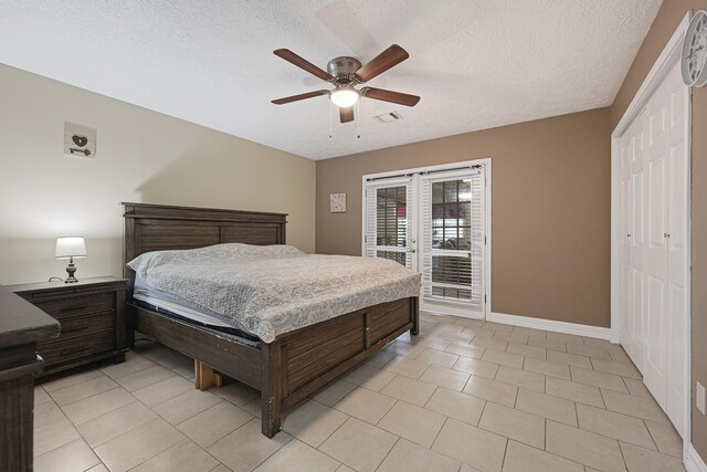 2218 Cherry Ln, Pasadena, TX 77502 - bedroom with a textured ceiling, access to exterior, light tile patterned floors, a ceiling fan, and baseboards