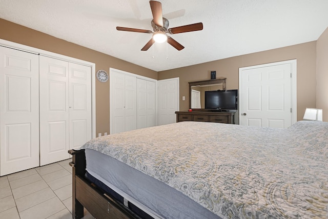 2218 Cherry Ln, Pasadena, TX 77502 - bedroom featuring two closets, light tile patterned floors, and ceiling fan