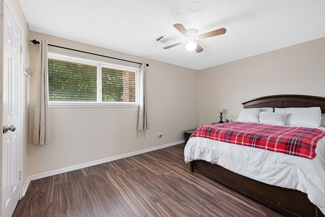 2218 Cherry Ln, Pasadena, TX 77502 - bedroom with wood finished floors, baseboards, a textured ceiling, and ceiling fan