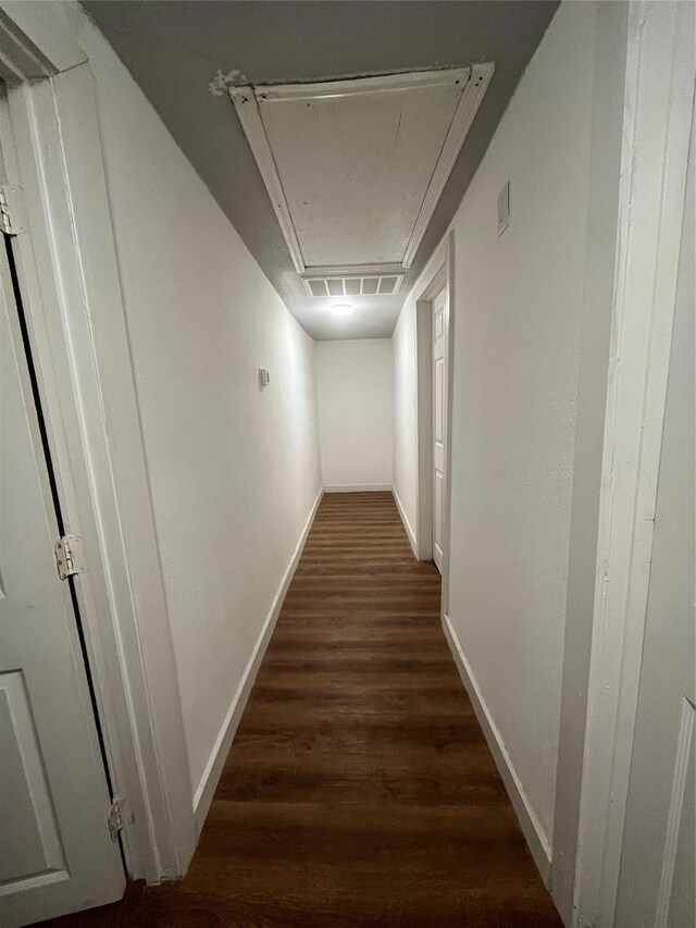 4416 Quitman St, Houston, TX 77026 - hallway featuring attic access, wood finished floors, and baseboards