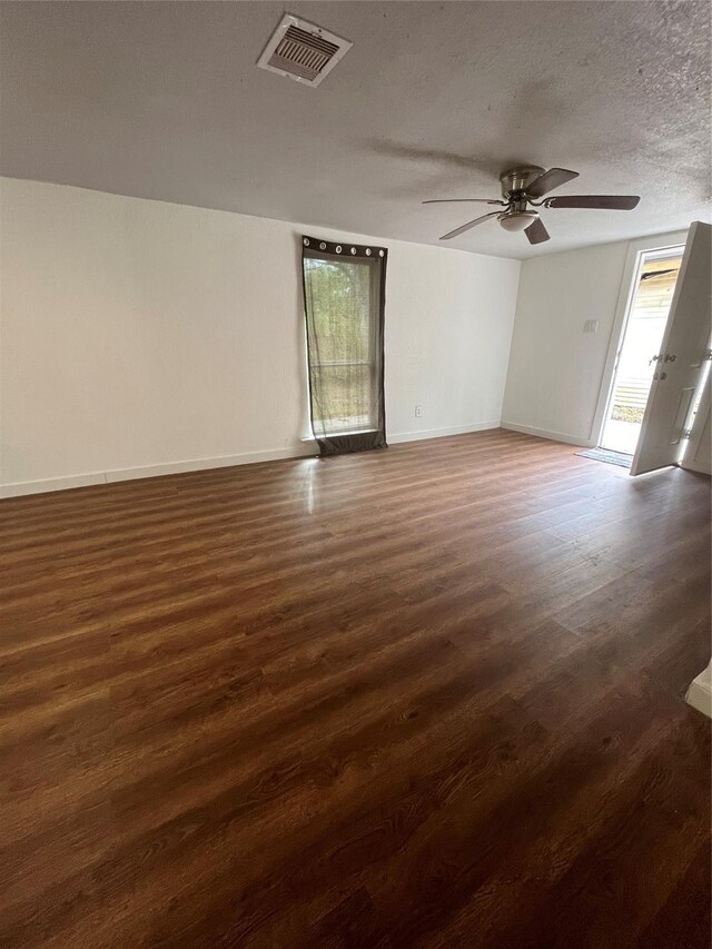 4416 Quitman St, Houston, TX 77026 - spare room featuring ceiling fan, wood finished floors, baseboards, and a textured ceiling