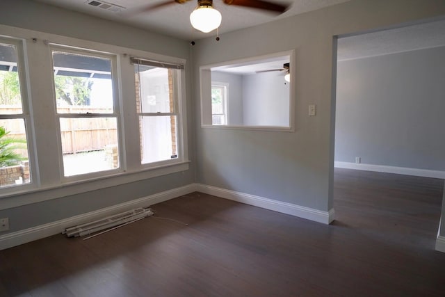 4737 Jefferson St, Houston, TX 77023 - empty room featuring ceiling fan, plenty of natural light, dark wood-style flooring, and baseboards