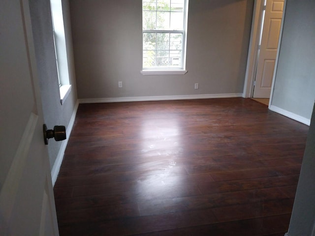 2152 William Tell St, Houston, TX 77093 - unfurnished bedroom featuring multiple windows, dark wood-type flooring, and baseboards