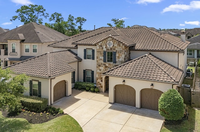 6407 Caparra Rock Ln, Sugar Land, TX 77479 - view of front of house featuring a garage, stucco siding, a tile roof, and driveway
