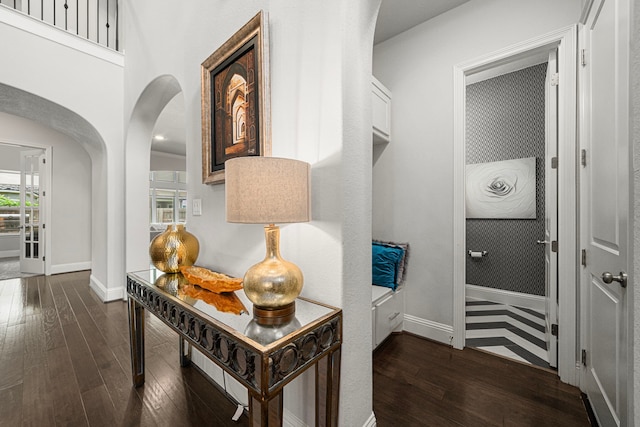 6407 Caparra Rock Ln, Sugar Land, TX 77479 - hall with dark wood finished floors, arched walkways, and baseboards