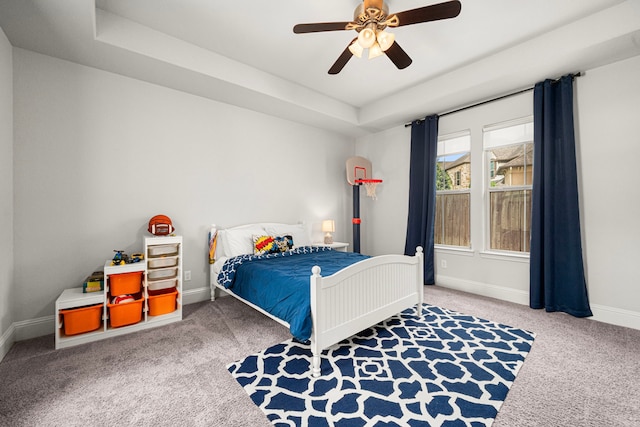 6407 Caparra Rock Ln, Sugar Land, TX 77479 - bedroom featuring carpet flooring, baseboards, ceiling fan, and a tray ceiling