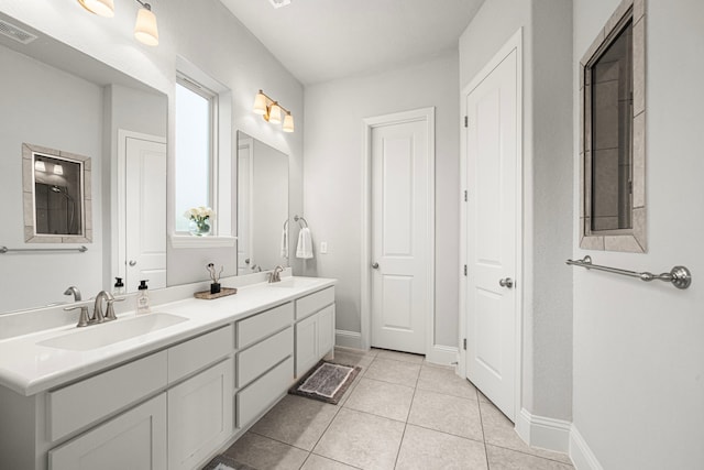 6407 Caparra Rock Ln, Sugar Land, TX 77479 - bathroom with double vanity, tile patterned floors, and baseboards