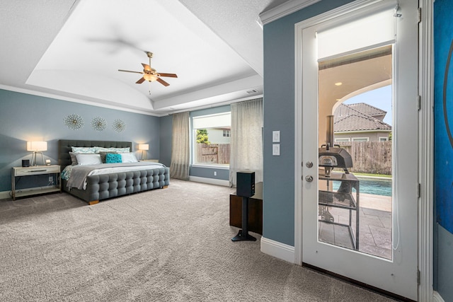 6407 Caparra Rock Ln, Sugar Land, TX 77479 - bedroom with baseboards, a tray ceiling, carpet, and a ceiling fan