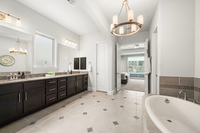 6407 Caparra Rock Ln, Sugar Land, TX 77479 - full bathroom featuring a chandelier, double vanity, a bath, and ensuite bathroom
