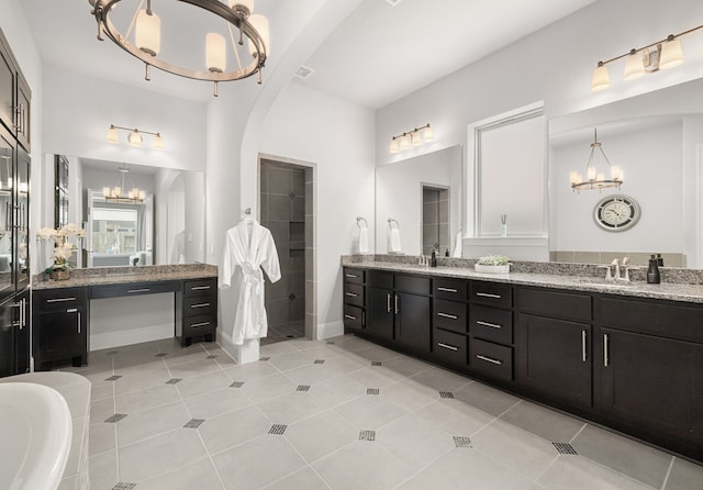6407 Caparra Rock Ln, Sugar Land, TX 77479 - bathroom featuring a chandelier, a shower stall, double vanity, and tile patterned floors