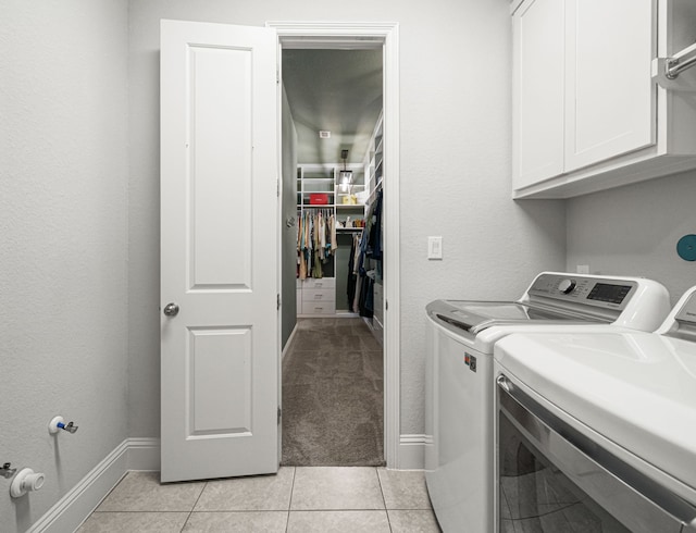 6407 Caparra Rock Ln, Sugar Land, TX 77479 - laundry area featuring cabinet space, separate washer and dryer, light tile patterned flooring, and baseboards