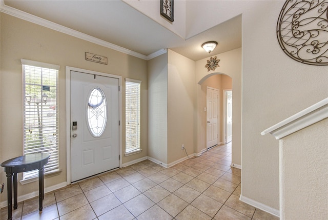 10531 Sunflower Dr, Willis, TX 77318 - entrance foyer with arched walkways, light tile patterned floors, crown molding, and baseboards