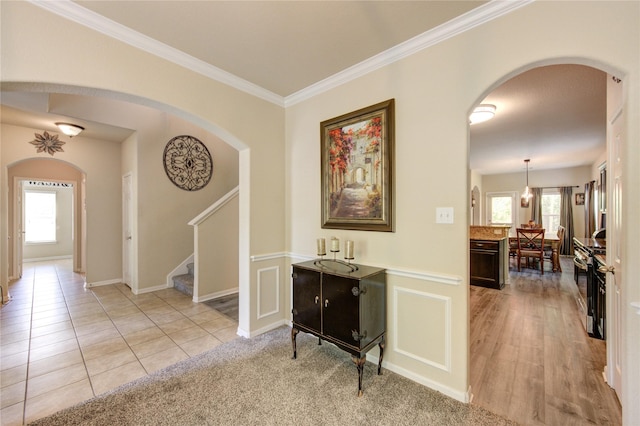10531 Sunflower Dr, Willis, TX 77318 - hall featuring healthy amount of natural light, stairs, ornamental molding, and arched walkways