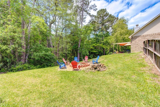 10531 Sunflower Dr, Willis, TX 77318 - view of grassy yard with a fire pit and a patio