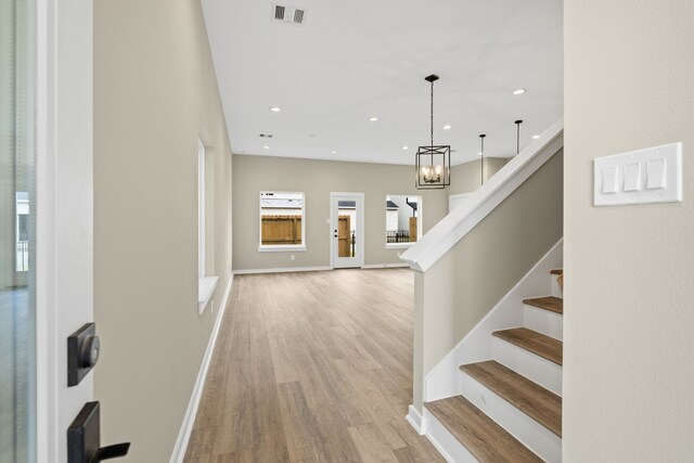11326 Stonework Grove Ln, Houston, TX 77076 - foyer with light wood-style floors, stairs, baseboards, recessed lighting, and a chandelier