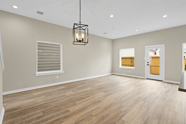 11326 Stonework Grove Ln, Houston, TX 77076 - empty room with a chandelier, light wood-style flooring, recessed lighting, and baseboards