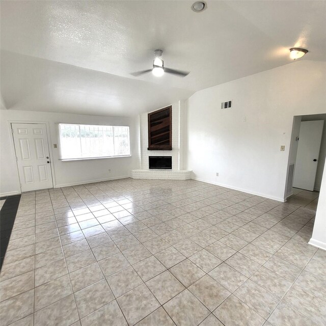17223 Artwood Ln, Houston, TX 77489 - unfurnished living room featuring ceiling fan, light tile patterned flooring, lofted ceiling, a fireplace, and baseboards