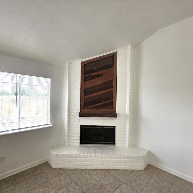 17223 Artwood Ln, Houston, TX 77489 - unfurnished living room with lofted ceiling, tile patterned floors, a brick fireplace, and baseboards