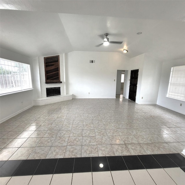 17223 Artwood Ln, Houston, TX 77489 - unfurnished living room featuring vaulted ceiling, a ceiling fan, tile patterned floors, a brick fireplace, and baseboards
