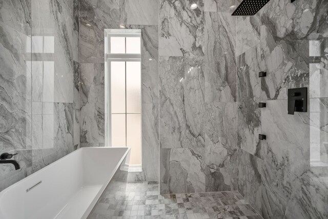 1139 W 22nd St, Houston, TX 77008 - bathroom featuring a soaking tub, a marble finish shower, and tile walls