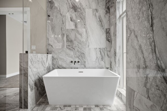 1139 W 22nd St, Houston, TX 77008 - full bathroom featuring tile walls, a freestanding bath, and marble tiled flooring